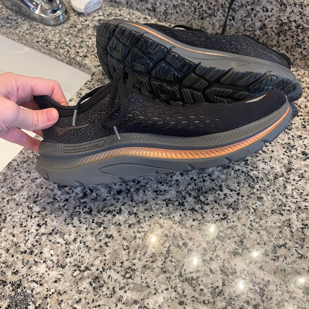 Black and gold Hoka running shoes